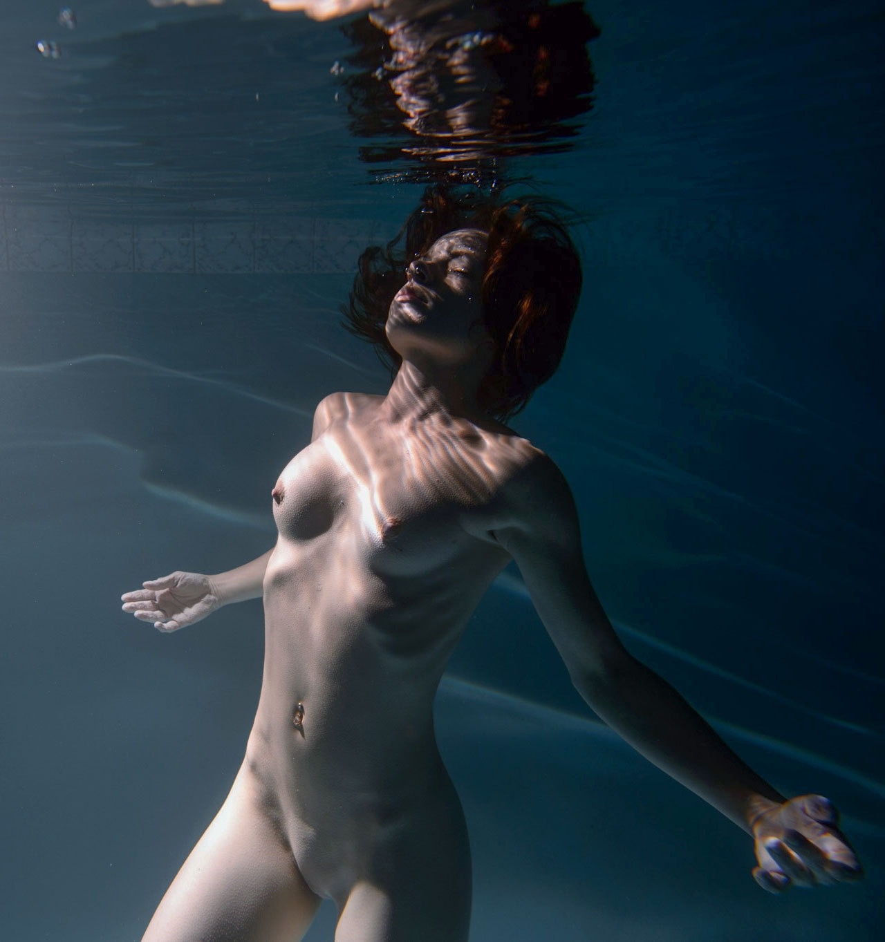 Nude woman scuba